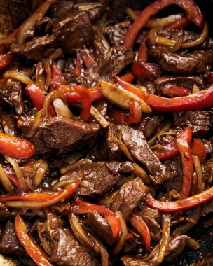Chopped Hawaiian steak in wok with carrots and other vegetables. Sticky sauce. High quality photo