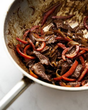 Chopped Hawaiian steak in wok with carrots and other vegetables. Sticky sauce. High quality photo