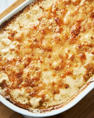 Scallops baked under creamy sauce. High quality photo