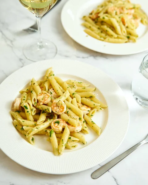 Pasta with shrimps, garlic, lemon and parsley. Penne with shelled shrimps. High quality photo