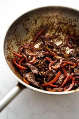 Chopped Hawaiian steak in wok with carrots and other vegetables. Sticky sauce. High quality photo