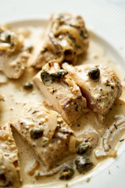 Chicken breasts in mustard sauce on white plate. High quality photo