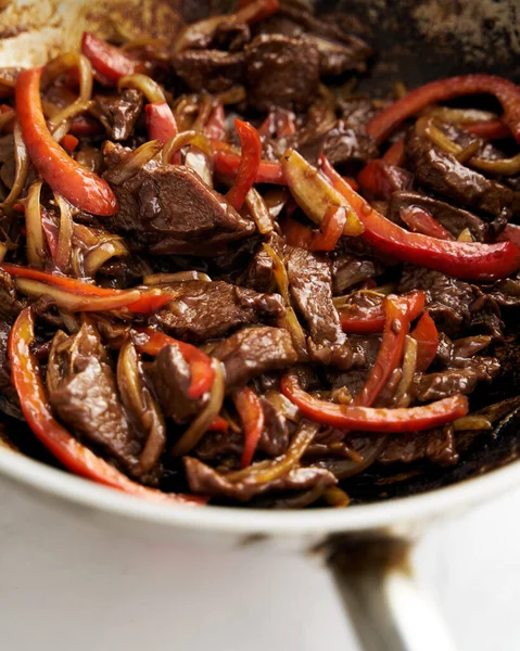 Chopped Hawaiian steak in wok with carrots and other vegetables. Sticky sauce. High quality photo