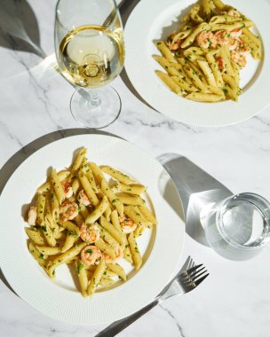 Pasta with shrimps, garlic, lemon and parsley. Penne with shelled shrimps. High quality photo