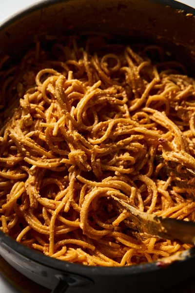 stock image Pot of mexican pasta. Pasta with tomato sauce with chilli puree, feta and cream cheese. Spaghetti macaroni boiled al dente and mixed with sauce. High quality photo