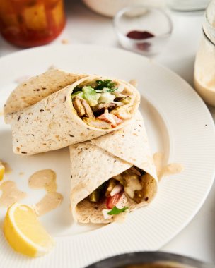 Sığır eti ve kuzu Lübnan usulü, soğanlı, yeşillikli, sebzeli salatalık ve domatesli shawarma. Hepsi tahin ve sarımsak sosuyla tatlandırılmış ve pide ya da pita ekmeğine sarılmış. Yüksek kalite fotoğraf