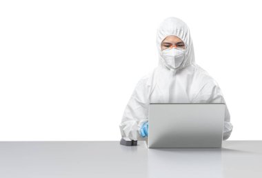 Worker wears medical protective suit or white coverall suit with mask and goggles with computer notebook isolated on white background