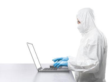Worker wears medical protective suit or white coverall suit work with computer notebook isolated on white background