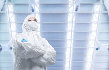 Worker or engineer wears protective suit or white coverall suit work in semiconductor manufacturing factory