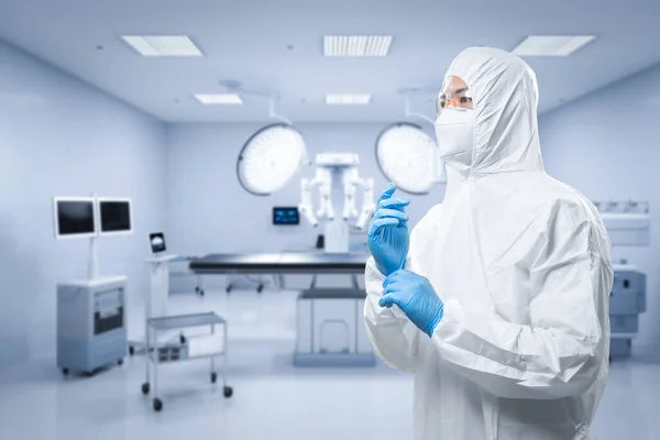 Doctor wears medical protective suit or white coverall suit in surgery room