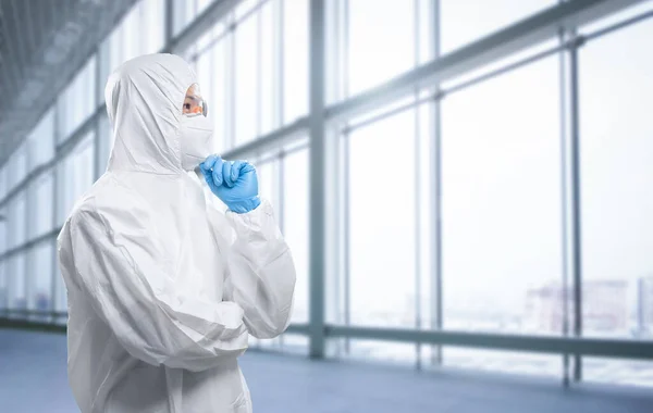 Worker wears medical protective suit or white coverall suit with mask and goggles analyze