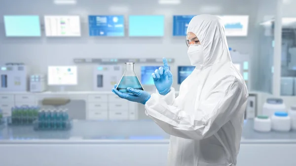 Worker wears medical protective suit or white coverall suit with flask in laboratory