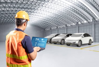 Fabrikada her arabayla Asyalı mühendis veya teknisyen çalışıyor.