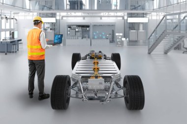 Fabrikada her arabayla Asyalı mühendis veya teknisyen çalışıyor.