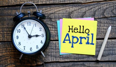HELLO APRIL words on a small piece of paper.