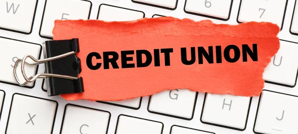 CREDIT UNION on a small red piece of paper.