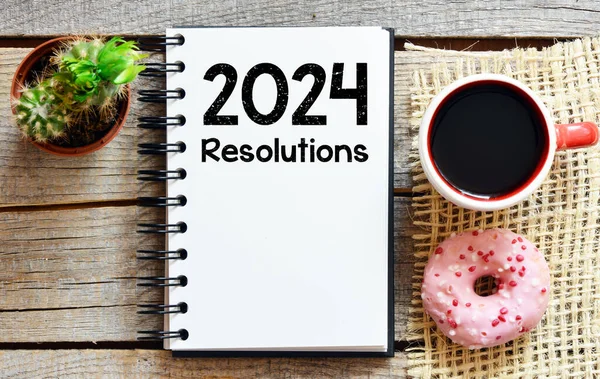 stock image 2024 resolutions in an office notebook.