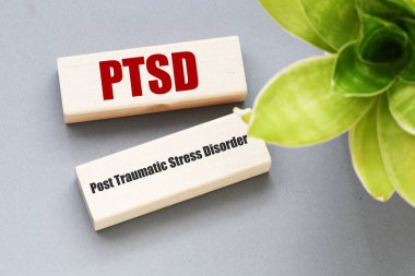 PTSD post traumatic stress disorder words on wooden blocks. clipart