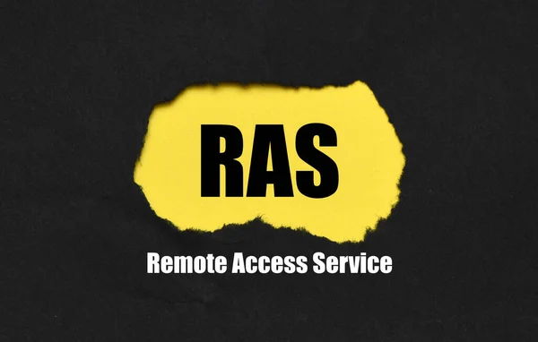 RAS Remote Access Service words on a yellow and black sheet of paper.