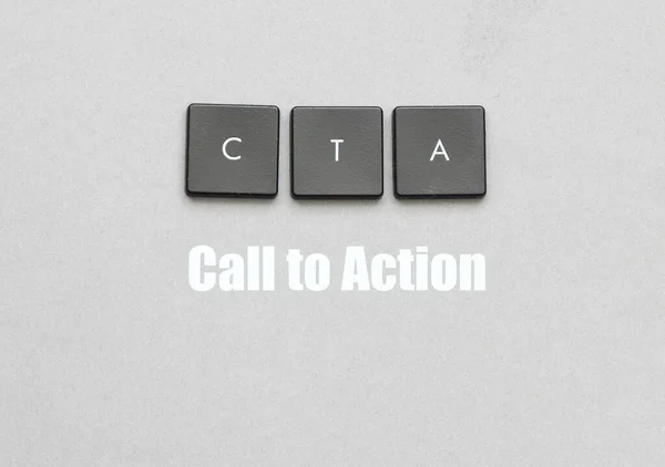 CTA (Call to Action) words on keys and gray sheet of paper.