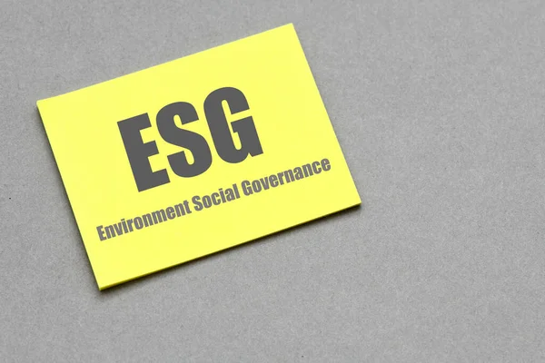 ESG Environment Social Governance words on a small piece of paper.