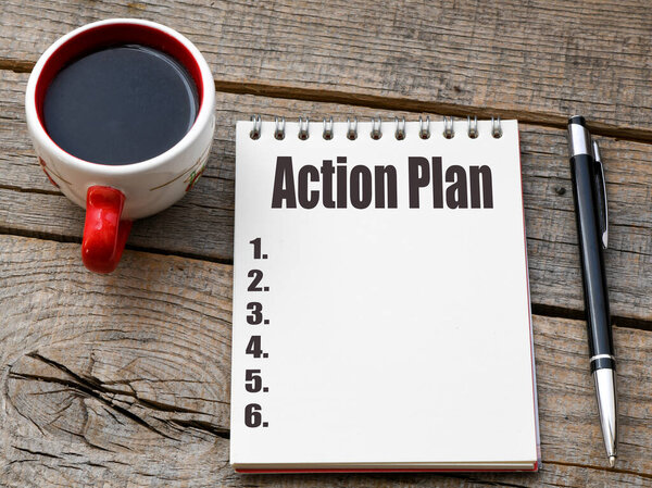 ACTION PLAN words in an office notebook.