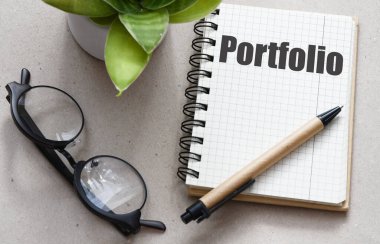 The word portfolio in an office notebook. clipart