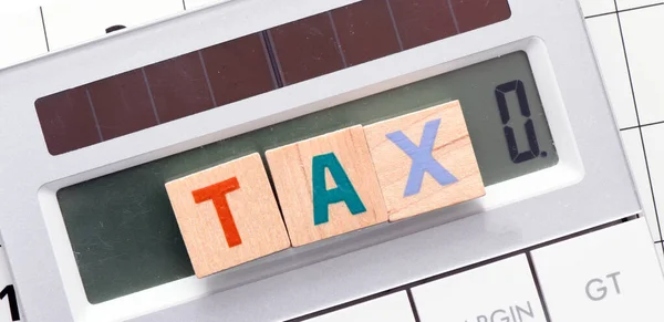 Tax Word Arranged Wooden Letters Calculator Screen — Stock Photo, Image