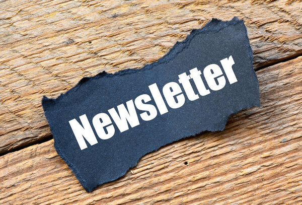 NEWSLETTER word on a small piece of paper.