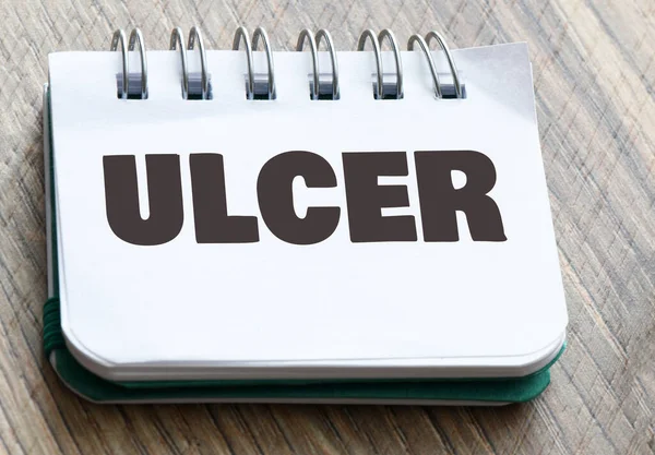 Слово Ulcer Блокноте Рядом Стетоскопом — стоковое фото