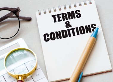 Terms and Conditions words in an office notebook. clipart