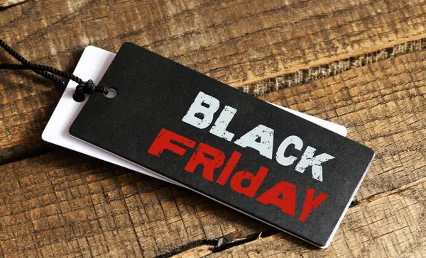 stock image Black Friday words written on a piece of paper. Time for promotions and sales in stores.