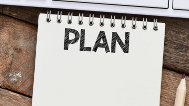 Ofis defterine yazılmış bir kelime planla. İş hayatında kavram. Yeni yıl için planlar.