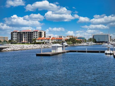 Pensacola Körfezi marinası. Uçsuz bucaksız bulutlu gökyüzünün altında rıhtımların ve teknelerin manzarası..
