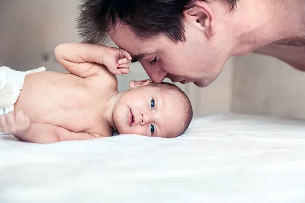 Father Kisses His Newborn Son Stock Photo