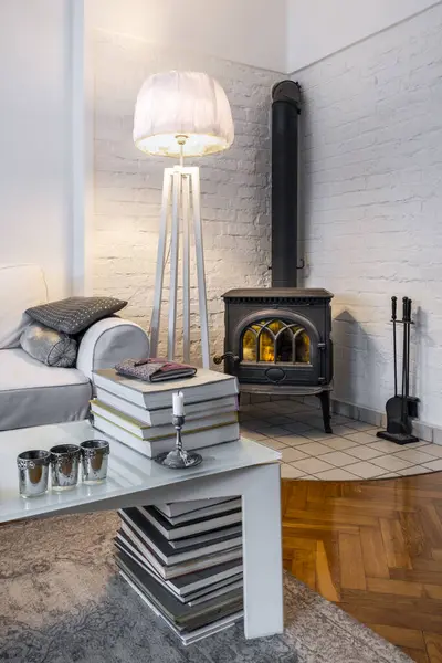 Vintage fireplace in modern interior design with white walls