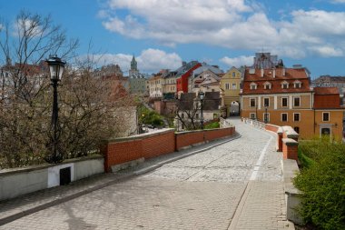 View of traditional colored tenements houses on the Old Town of Lublin city during sunny spring day. clipart