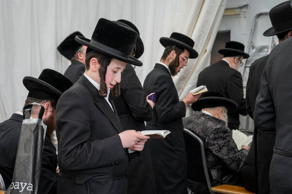 Lezajsk, Poland - March 31, 2024: Members of the Jewish diasphora during the 2024 pilgrimage of Hasidic Jews from around the world to the grave of Tzadik Elimelech Weissblum in Lezajsk near Rzeszow in South-Eastern Poland.