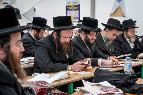 Lezajsk, Poland - March 31, 2024: Members of the Jewish diasphora during the 2024 pilgrimage of Hasidic Jews from around the world to the grave of Tzadik Elimelech Weissblum in Lezajsk near Rzeszow in South-Eastern Poland.