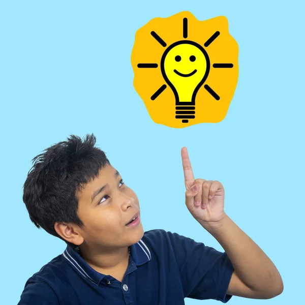 stock image Child looking happy and pointing at light bulb. Success, idea, win and innovation technology.