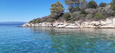 Azure Aegean sea view. Vourvourou village, Diaporos island. North Greece, Central Macedonia, Chalkidiki peninsula, Sithonia.  clipart