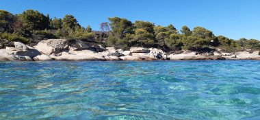 Azure Aegean sea view. Vourvourou village, Diaporos island. North Greece, Central Macedonia, Chalkidiki peninsula, Sithonia.  clipart