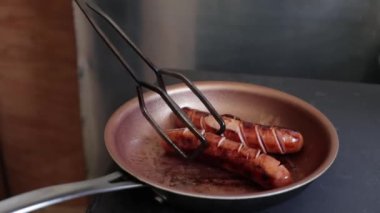 Kızarmış sosis. Tava pişiriyorum. Yakından ızgara sosis..