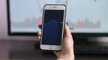 Stock Market. Exchange Chart. Checking stock market data. Mobile phone screen.