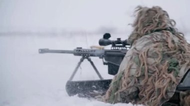 Sniper in winter. War in Ukraine. Combat sniper on a mission. Sniper weapon.