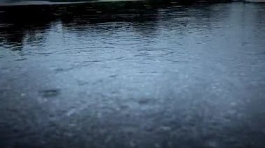 A calming and peaceful view of rain gently falling on a reflective surface, beautifully capturing the essence of nature