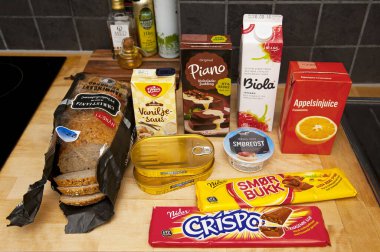 OSLO, NORWAY - AUGUST 26, 2016: Grocery shopping set of Norwegian food products in the kitchen. Inflation - rising living costs. Nutrition - health care, dieting and lifestyle.