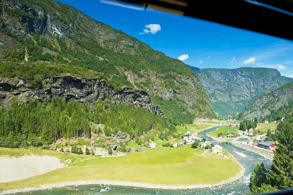Breathtaking Norwegian fjord and mountain landscapes seeing through the train window during The Flam Railway (Flamsbana) trip Myrdal - Flam on Norway in a Nutshell Tour