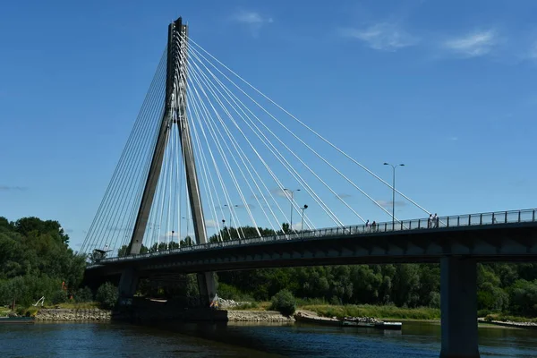 stock image WARSAW, POLAND - JUL 3: Swietokrzyski Bridge over the Vistula River in Warsaw, Poland, as seen on July 3, 2022. 