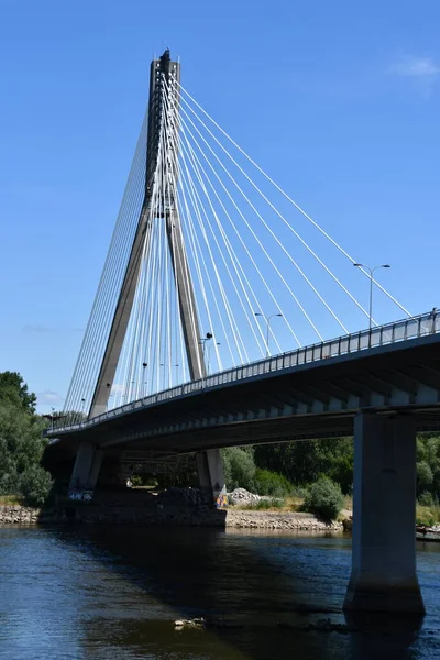 stock image WARSAW, POLAND - JUL 3: Swietokrzyski Bridge over the Vistula River in Warsaw, Poland, as seen on July 3, 2022. 